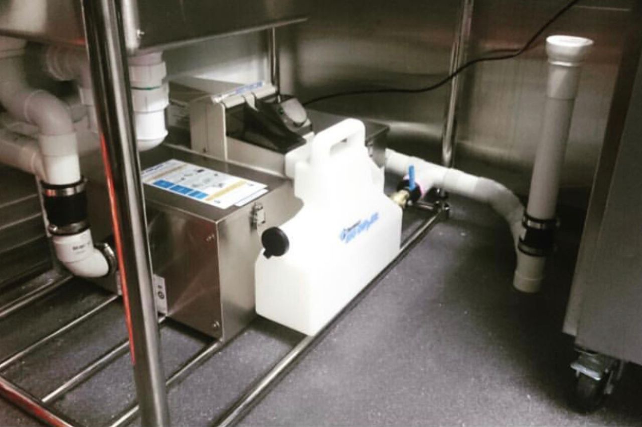 Indoor restaurant grease trap installed beside a dish area serving Beaumont, California