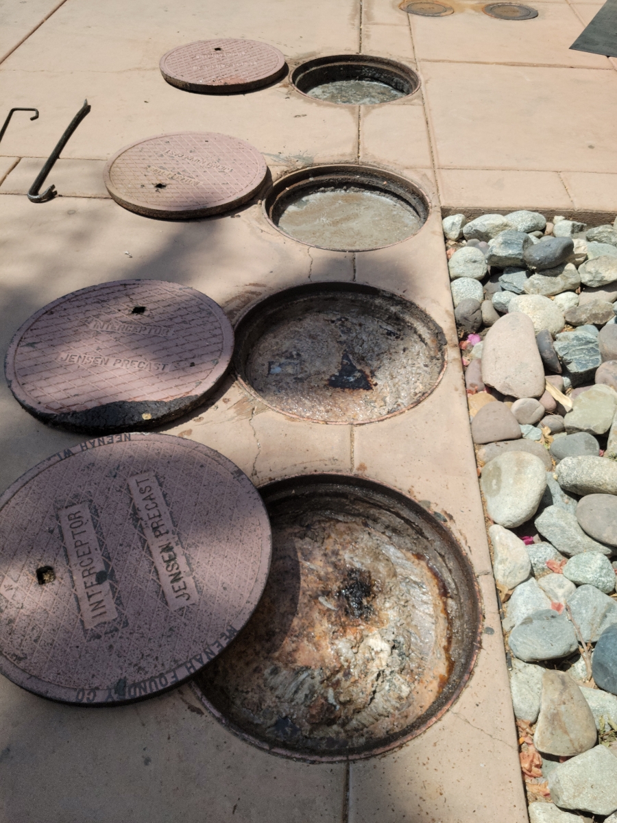 Multiple commercial grease interceptor compartments open for pumping serving Menifee, California
