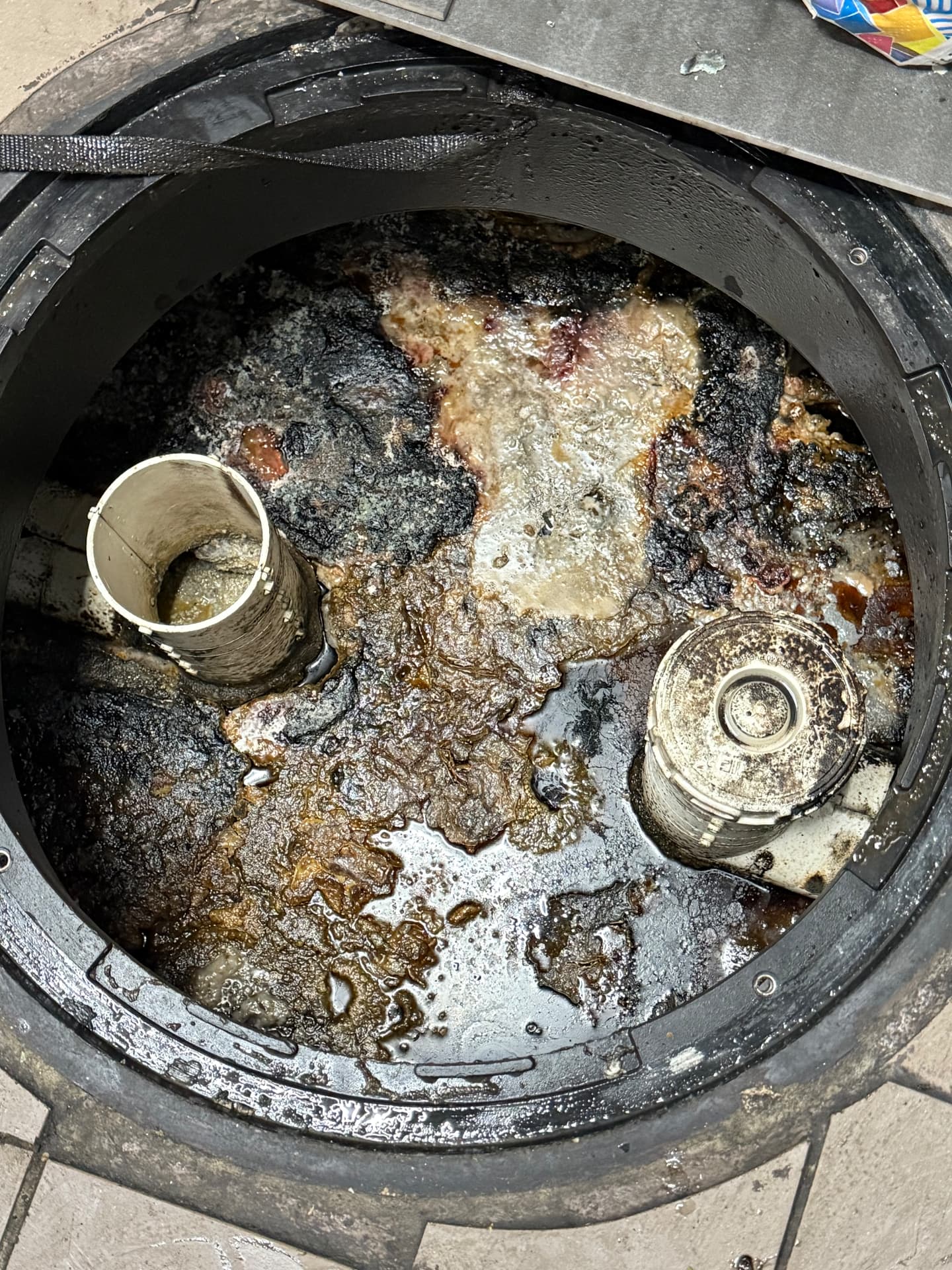 Grease interceptor packed with hardened grease and solids before pumping