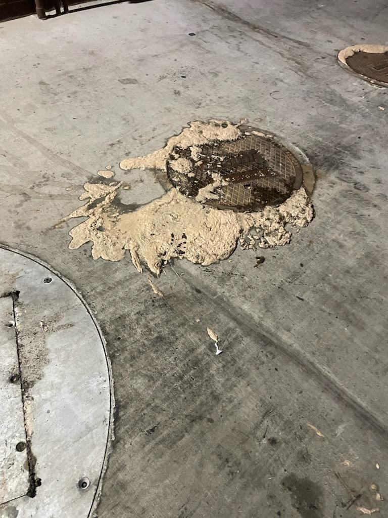 Grease overflowing from a kitchen floor sink before emergency service in Beaumont, California
