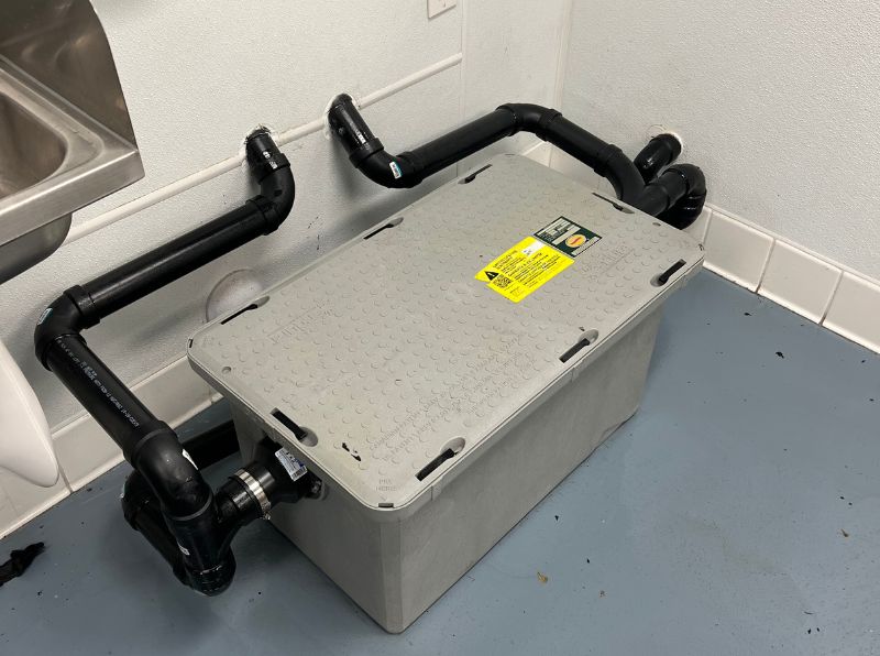 Under-sink grease trap in a commercial kitchen