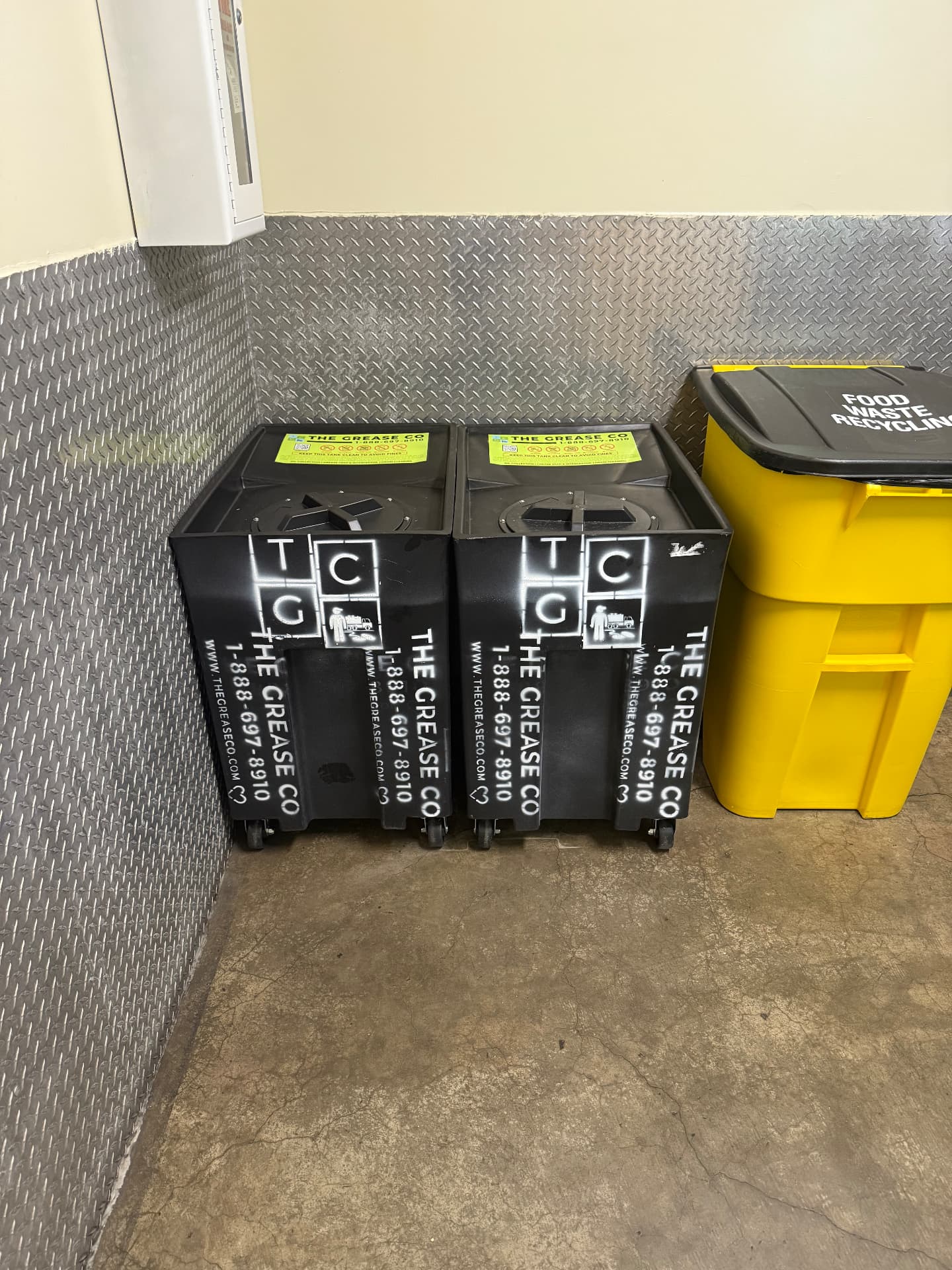 Sealed used cooking oil collection bins staged inside a restaurant back room in Blythe, California