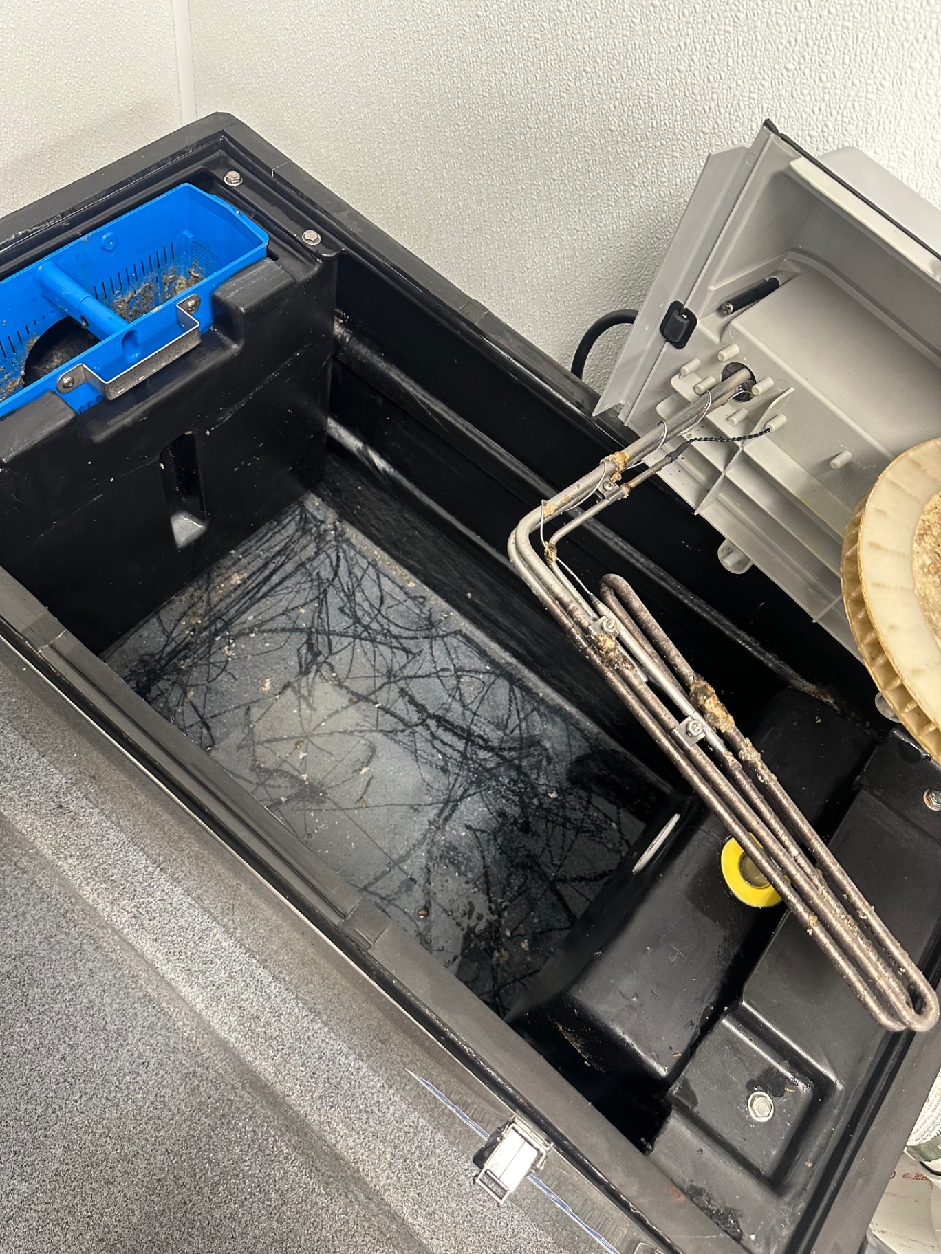 Small indoor grease trap serving a commercial kitchen in Menifee, California