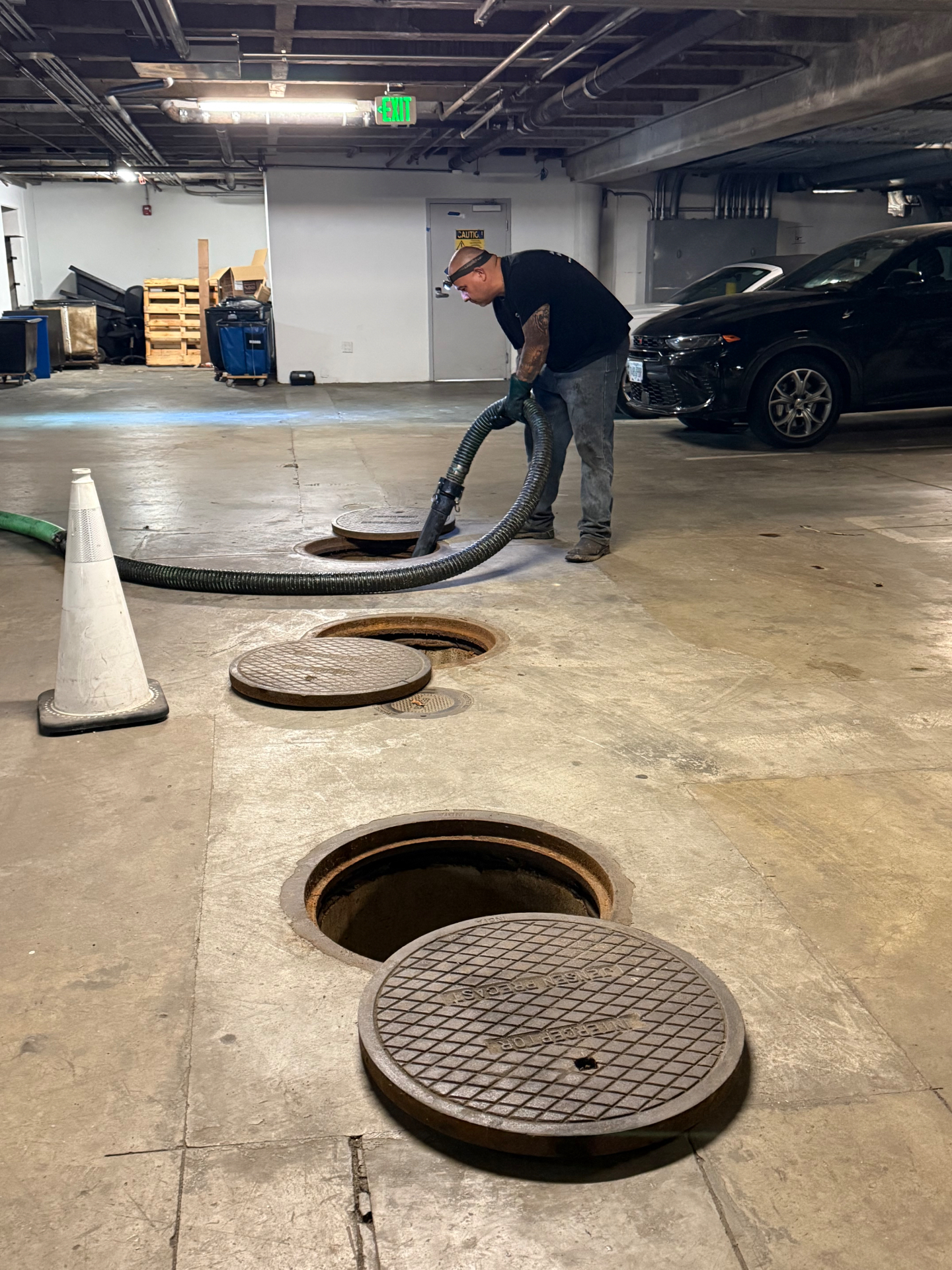 Large outdoor grease interceptor with open manholes ready for pumping in Beaumont, California